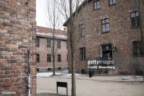 Visitors tour buildings at the Auscwitz-Birkenau concentration camp museum in Auscwitz-Birkenau, Poland, on Wednesday, Feb. 28, 2018. Poland is...