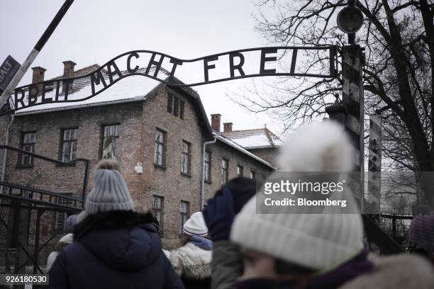 Visitors pass through the main gate bearing the inscription 'Arbeit Macht Frei' at the Auscwitz-Birkenau concentration camp museum in...