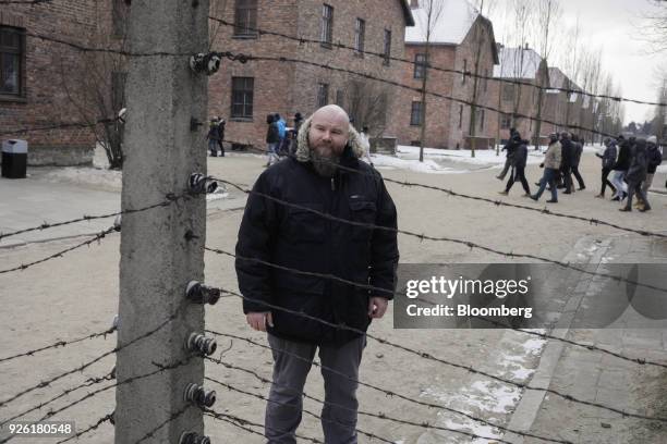 Bartosz Bartyzel, historian and spokesman of Auscwitz-Birkenau concentration camp museum, poses for a photograph in the grounds of the holocaust...
