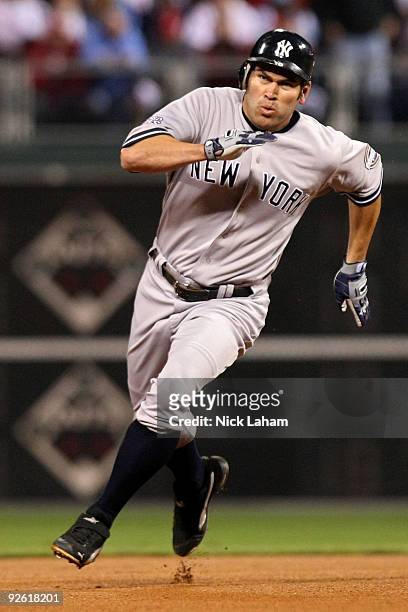 Johnny Damon of the New York Yankees runs towards third base as he scores on a RBI double by Alex Rodriguez in the top of the first inning against...
