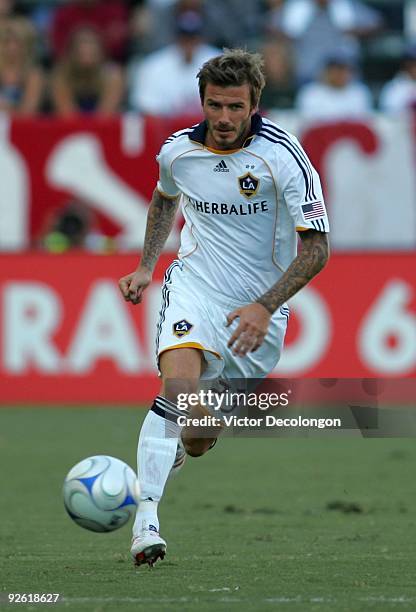 David Beckham of the Los Angeles Galaxy paces the ball through midfield during Game 1 of the MLS Western Conference Semifinals match action against...