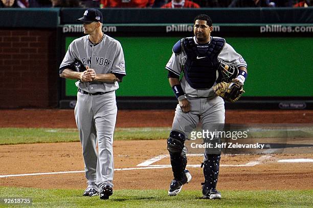 Burnett and Jose Molina of the New York Yankees stand on the field in the bottom of the first inning against the Philadelphia Phillies in Game Five...