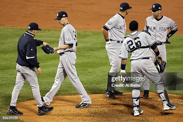 Manager Joe Girardi of the New York Yankees takes starting pitcher A.J. Burnett out of the game in the bottom of the third inning against the...