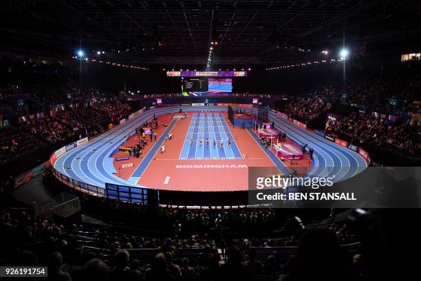 Athletes compete in the women's 60m hurdles pentathlon event at the 2018 IAAF World Indoor Athletics Championships at the Arena in Birmingham on...