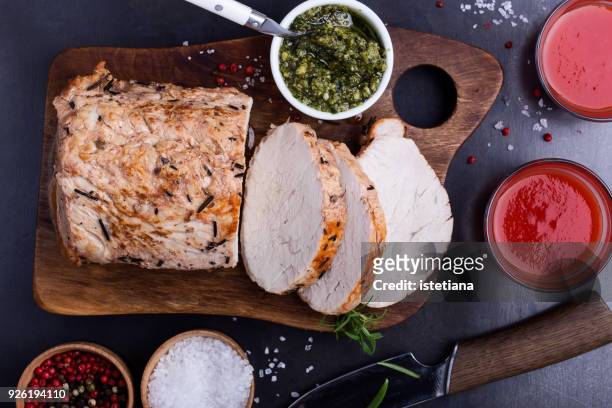 herb roasted pork loin on cutting board - loin stock pictures, royalty-free photos & images