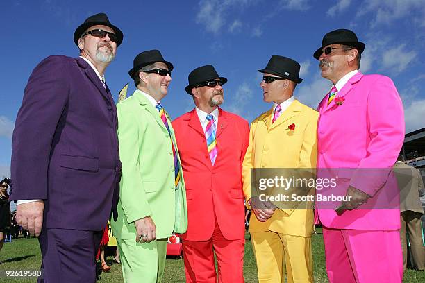 Racegoers in colourful suits talk as they arrive at the 2009 Melbourne Cup Day meeting at Flemington Racecourse on November 3, 2009 in Melbourne,...