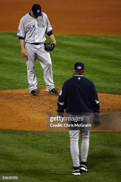 Pitching coach Dave Eiland of the New York Yankees walks out to the mound to talk to Alfredo Aceves against the Philadelphia Phillies in Game Five of...