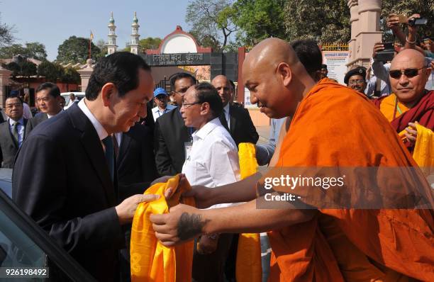 Vietnam's President Tran Dai Quang is welcomed by Buddhist monks as he visits the Mahabodhi temple, a UNESCO World Heritage Site and important...