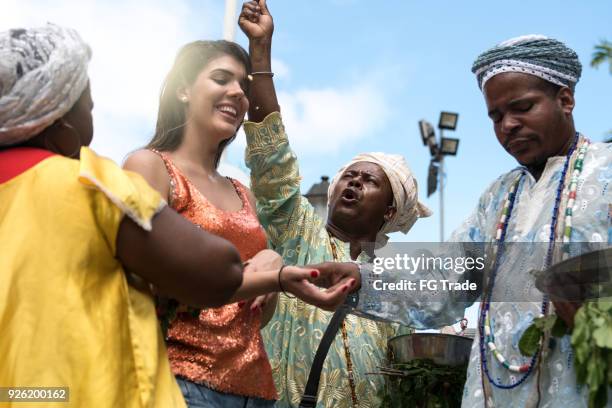 candomble group blessing a woman - santeria stock pictures, royalty-free photos & images