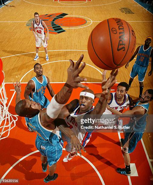 Al Harrington of the New York Knicks shoots against David West of the New Orleans Hornets on November 2, 2009 at Madison Square Garden in New York...