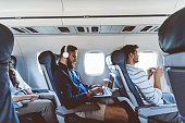 Male passenger using laptop during flight