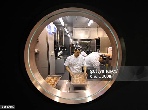 To go with story Lifestyle-China-Spain-food-gastronomy by Pascale Trouillaud Chinese cooks make the last preparations for a demonstration by Spanish...