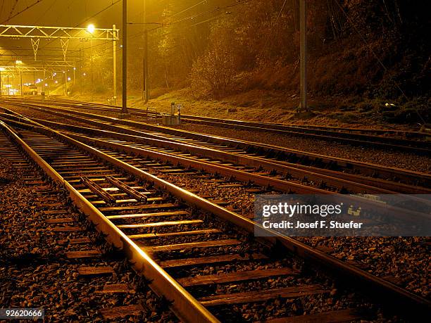 rails by night - railroad track stock pictures, royalty-free photos & images