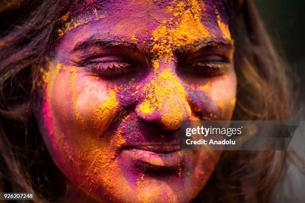 An Indian girl's face is smeared in color as she celebrates Holi, the Hindu festival of colors, in Mumbai, India on March 02, 2018. The festival, a...