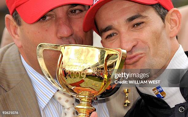 Trainer Mark Kavanagh and jockey Corey Brown celebrate with the trophy after winning the Melbourne Cup on their horse Shocking on November 3, 2009....