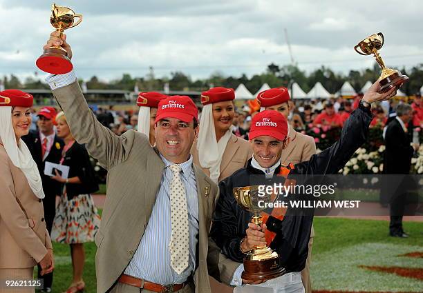 Trainer Mark Kavanagh and jockey Corey Brown celebrate with the trophy after winning the Melbourne Cup on their horse Shocking on November 3, 2009....