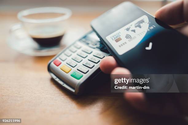 contactless payment in the coffee shop - digital-wallet stock pictures, royalty-free photos & images