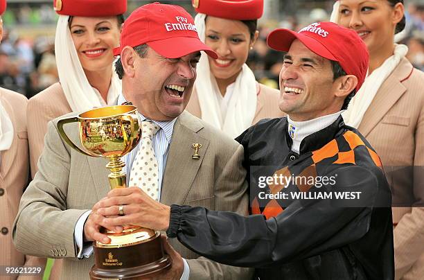 Trainer Mark Kavanagh and jockey Corey Brown celebrate with the trophy after winning the Melbourne Cup on their horse Shocking on November 3, 2009....