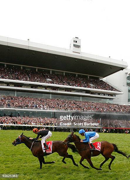 Jockey Corey Brown riding Shocking wins the Emirates Melbourne Cup ahead of Kerrin McEvoy riding Crime Scene during the 2009 Melbourne Cup Day...