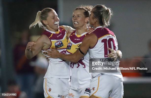 Kate McCarthy, Brittany Gibson and Kaitlyn Ashmore of the Lions celebrate during the 2018 AFLW Round 05 match between the Melbourne Demons and the...