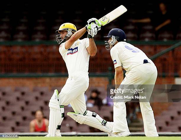 Theo Doropoulos of the Warriors hits out during day one of the Sheffield Shield match between the New South Wales Blues and the Western Australian...