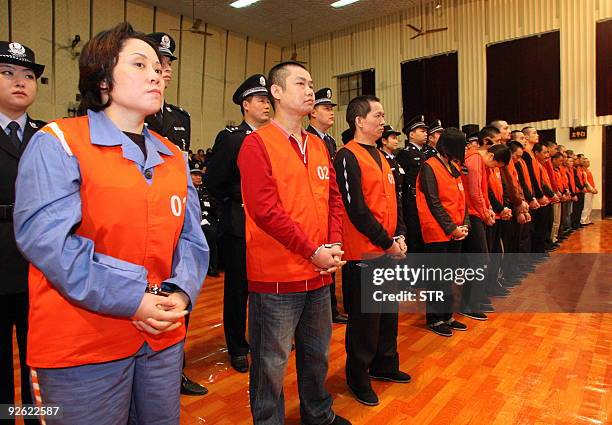 This photo taken on October 14, 2009 shows Xie Caiping , the alleged gang godmother, standing with the other defendants during a trial in the...