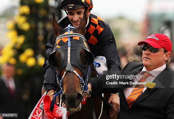 Jockey Corey Brown riding Shocking celebrates with owner Laurence Eales as they return to scale having won the 2009 Emirates Melbourne Cup during the...