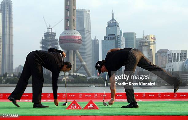 Tiger Woods, and Phil Mickelson of the USA tee up their golf balls before hitting into the Huangpu River during the the Official 2009 WGC-HSBC...