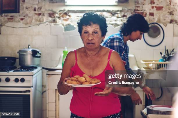 multi-generation cuban family preparing dinner - cuban ethnicity stock pictures, royalty-free photos & images