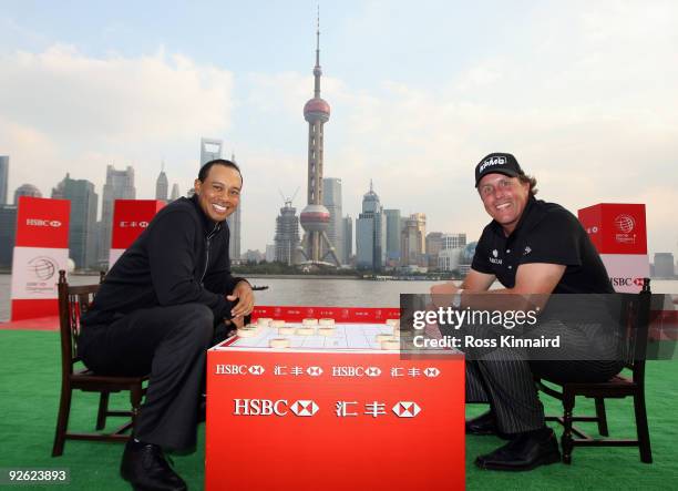 Tiger Woods, and Phil Mickelson of the USA pose at a Chinese chess table during the the Official 2009 WGC-HSBC Photocall at the Shanghai Port...