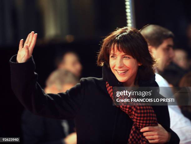 French actress Sophie Marceau waves on November 2, 2009 in Lomme, northern France, upon her arrival to attend the preview of "L'homme de chevet"...