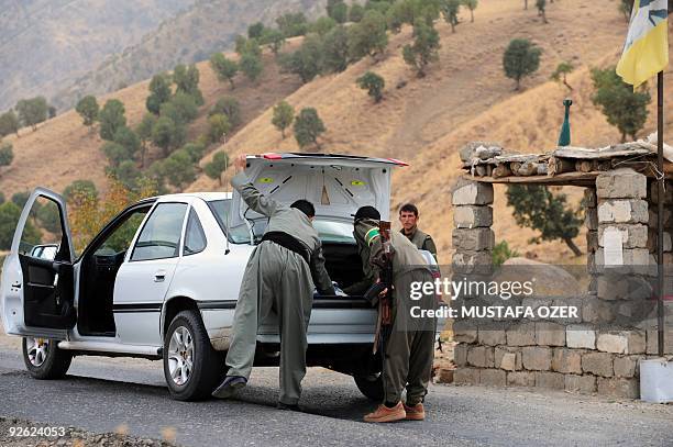 Kurdistan Worker's Party rebels stop a car at a security checkpoint on October 28, 2009 near a PKK base in the Qandil mountains, near Rania province,...