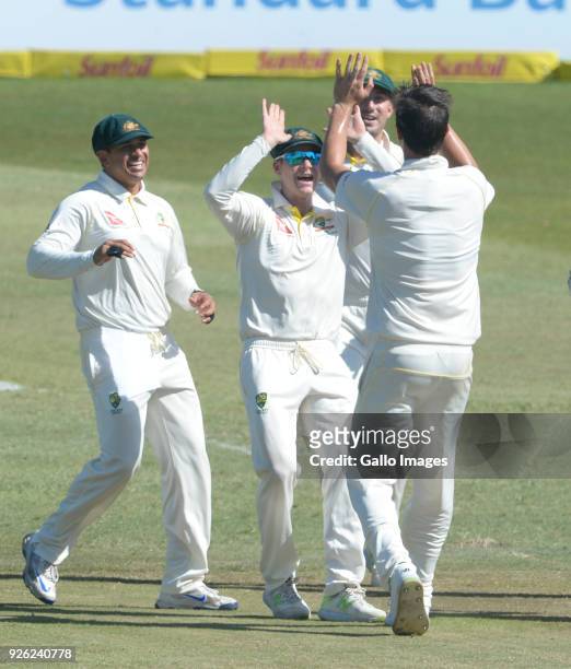 Steven Smith and Pat Cummins of Australia celebrate the wicket of Aiden Markram of the Proteas during day 2 of the 1st Sunfoil Test match between...