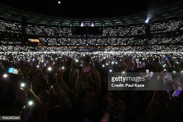 Concert-goers light their phones as Ed Sheeran performs in concert on the opening night of his Australian tour at Optus Stadium on March 2, 2018 in...