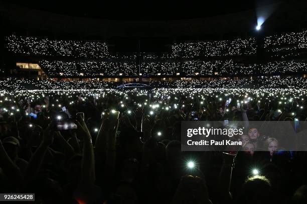 Concert-goers light their phones as Ed Sheeran performs in concert on the opening night of his Australian tour at Optus Stadium on March 2, 2018 in...