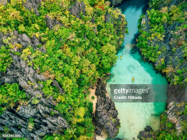 aerial view of beautiful lagoon with kayaks - philippines stock pictures, royalty-free photos & images