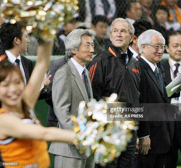 Former US president George W. Bush smiles with former Japanese prime minister Junichiro Koizumi before taking part in the ceremonial first pitch for...