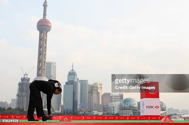 Tiger Woods of the USA tee up his golf ball before hitting into the Huangpu River during the the Official 2009 WGC-HSBC Photocall at the Shanghai...