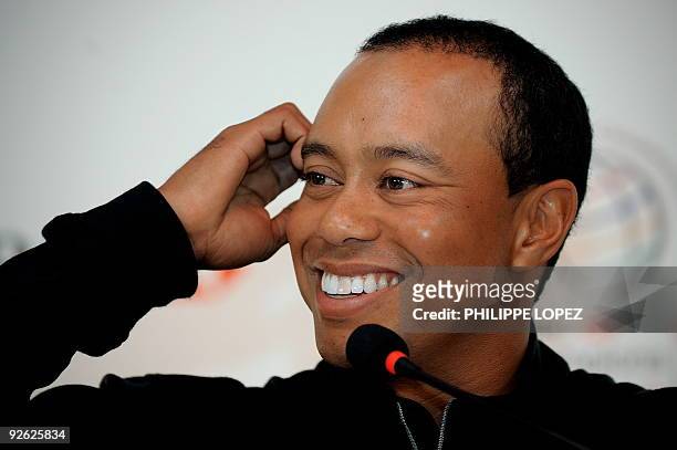 Golfers Tiger Woods smiles during a press conference in Shanghai on November 3, 2009 ahead of the HSBC Champions golf tournament, now elevated to...