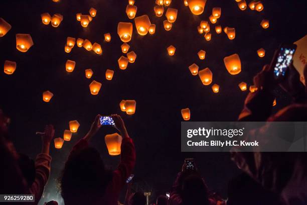 Tourists take photographs of sky lanterns during the Pingxi lantern festival on March 2, 2018 in Pingxi, Taiwan. Pingxi, a Taiwanese district known...