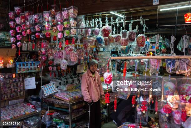 Local woman stands in her store selling lantern souvenirs on March 1, 2018 in Pingxi, Taiwan. Pingxi, a Taiwanese district known for its old train...