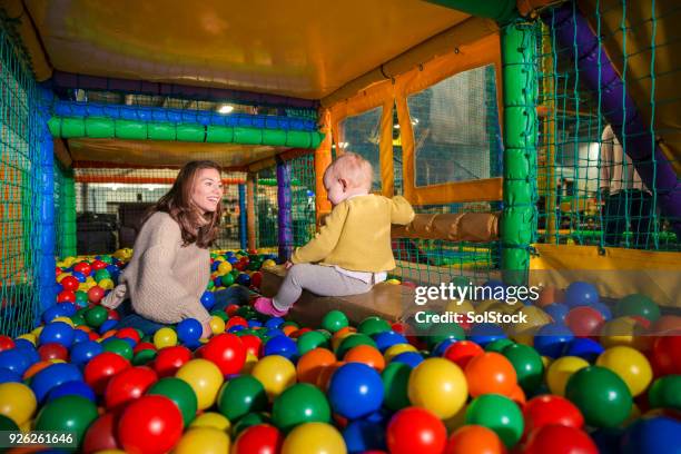 playing in the ball pool - adult ball pit stock pictures, royalty-free photos & images