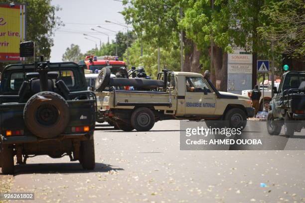Burkinabe gendarme vehicles block a street in Ouagadougou on March 2 as the capital of Burkina Faso came under multiple attacks targeting the French...