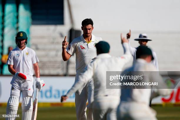 Australia bowler Mitchell Starc celebrates the wicket of South Africa batsman Theunis de Bruyn during day two of the first Test cricket match between...