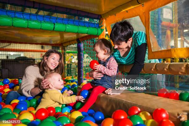 playing in the ball pool - adult ball pit stock pictures, royalty-free photos & images