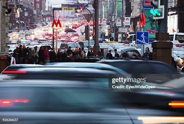 Enlighted Metro sign and traffic at rush hour around revolution square on October 14, 2009 in Moscow, Russia. Moscow is the biggest European City...