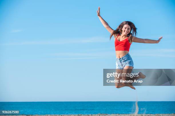 happy girl jumping on the beach on holidays - weight loss journey stock pictures, royalty-free photos & images