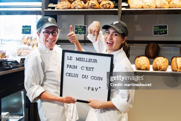two women, proud owners of a small local bakery shop. - french language stock pictures, royalty-free photos & images