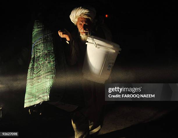 An internally displaced Pakistani tribesman, fleeing from military operations against Taliban militants in South Waziristan, leaves after receiving...