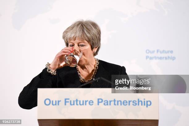 Theresa May, U.K. Prime minister, drinks water while delivering a speech on Brexit at Mansion House in London, U.K., on Friday, March 2, 2018. The...